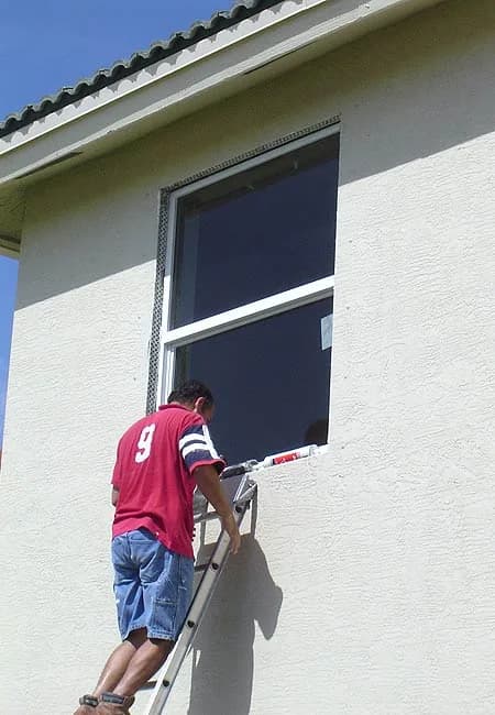 Fitting an impact window from a ladder