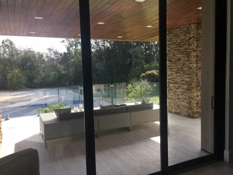 Covered lanai with timber ceiling and impact sliding glass