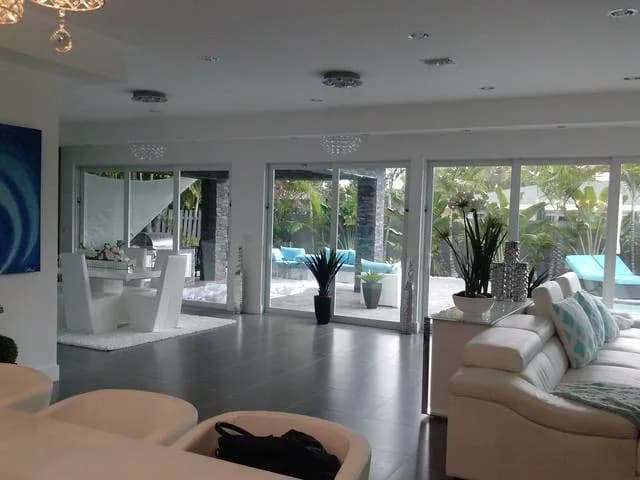 Bright living room with impact sliding doors to the pool