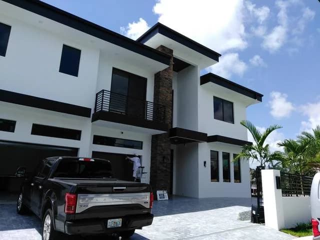 White contemporary two-storey with black-framed impact windows